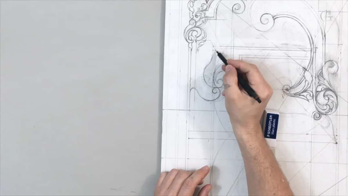 Right hand drawing a leaf on the left side, a white eraser in a blue sleeve lying below it