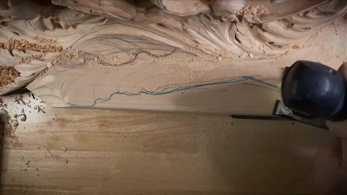 Jigsaw sitting on the board, its blade near a blue line that marks the waste to come off