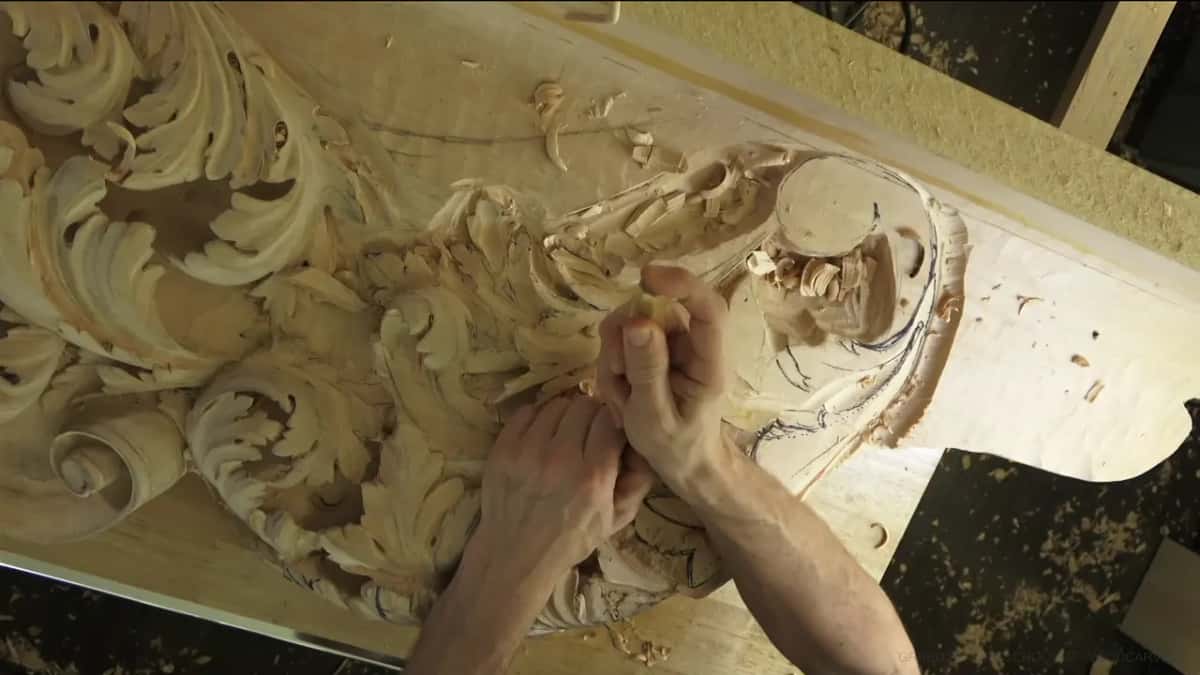 Knuckles bent over the new carving.