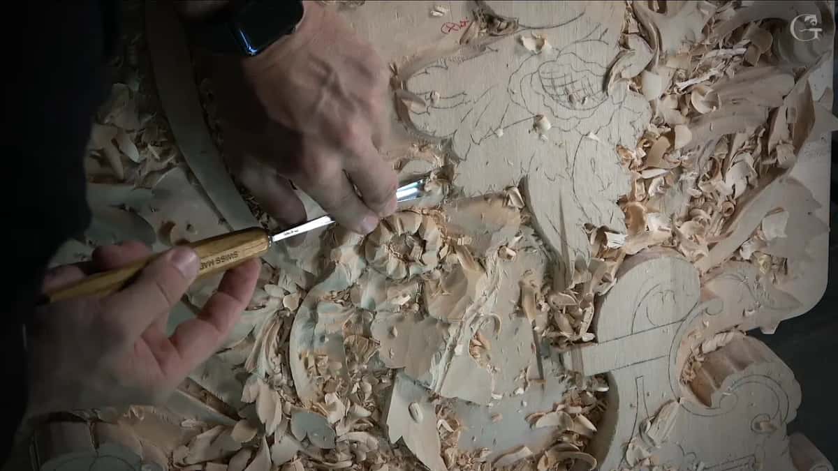 Pencil grid drawn on the second bloom while hands work the wood below it