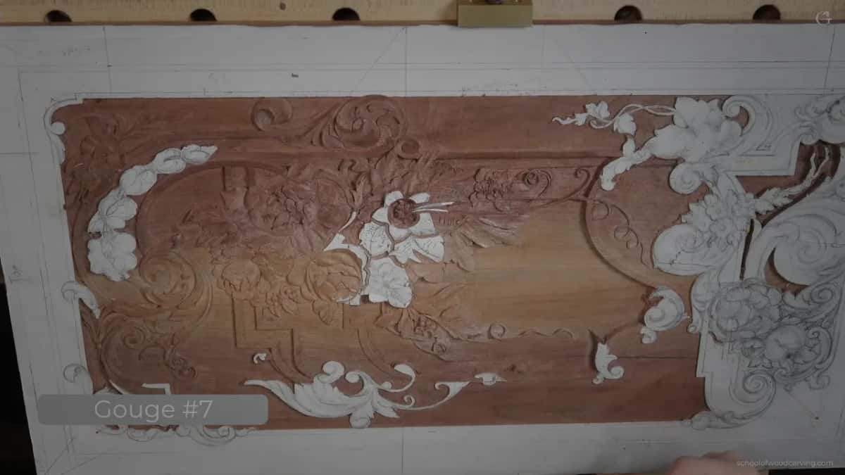 The whole panel seen from above with gouges laid across it, which is how he judges where light will fall once it hangs.
