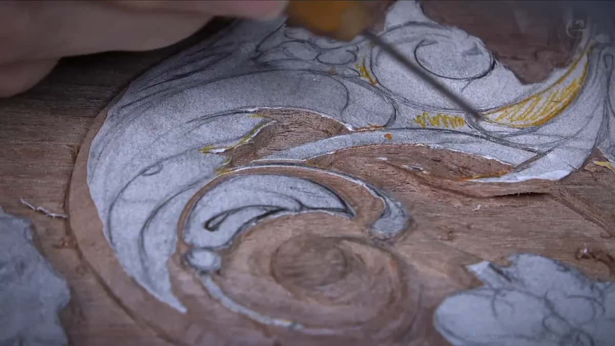 Long slim tool reaching across the drawn swirl from the upper right of the picture