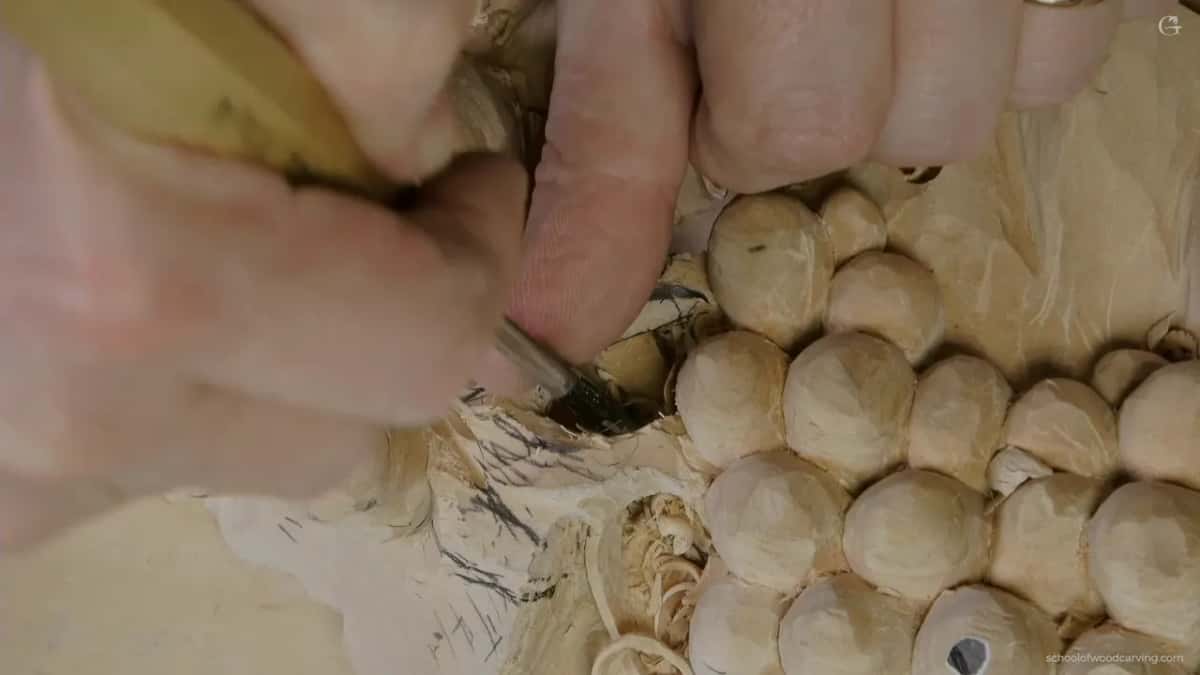 Fingertip pressed against the work as the brace, so no carved edge has to take it