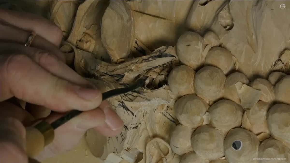 Hands low over the fruit, keeping the force running along the tool rather than down into the panel below