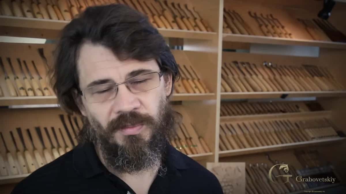 Years earlier, in front of a wall of carving tools, talking to the camera