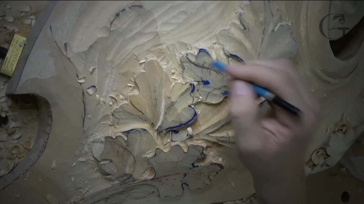 A blue marker drawing a line on one shaped leaf