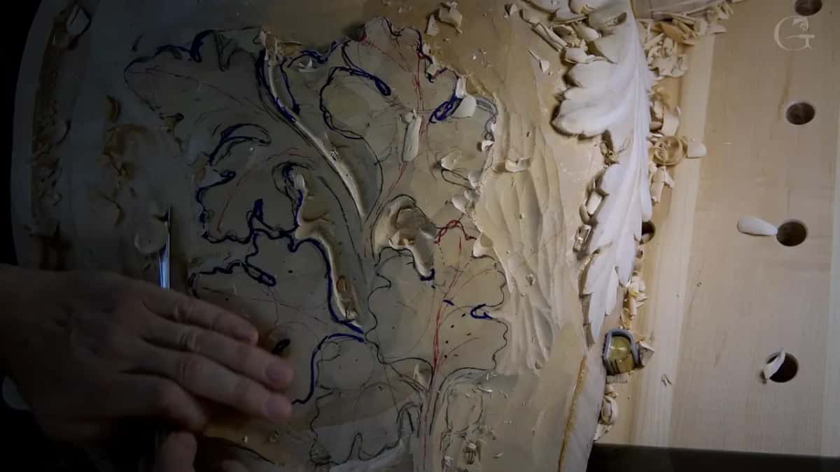 Blue marker outlines on a cluster of lobed leaves, a white carved acanthus leaf to the right