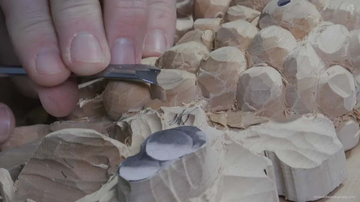 A scrap of pattern paper still sitting on the highest grape, which is how I avoid carving past full thickness