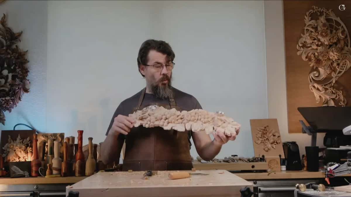 Alexander holding the carved grape panel up in the studio at the end of the session
