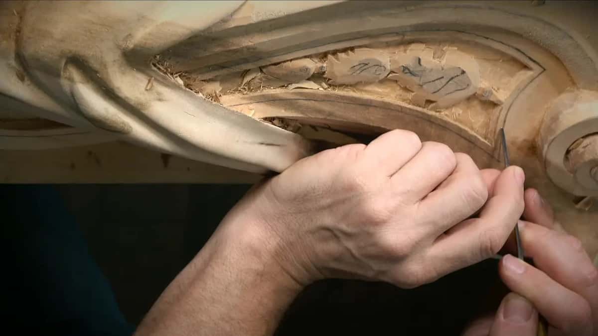 Fingers pinch a fine veiner at the panel edge