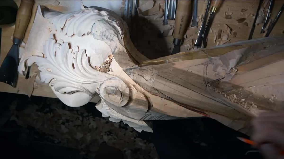 Pencil in hand, the lit carving waits