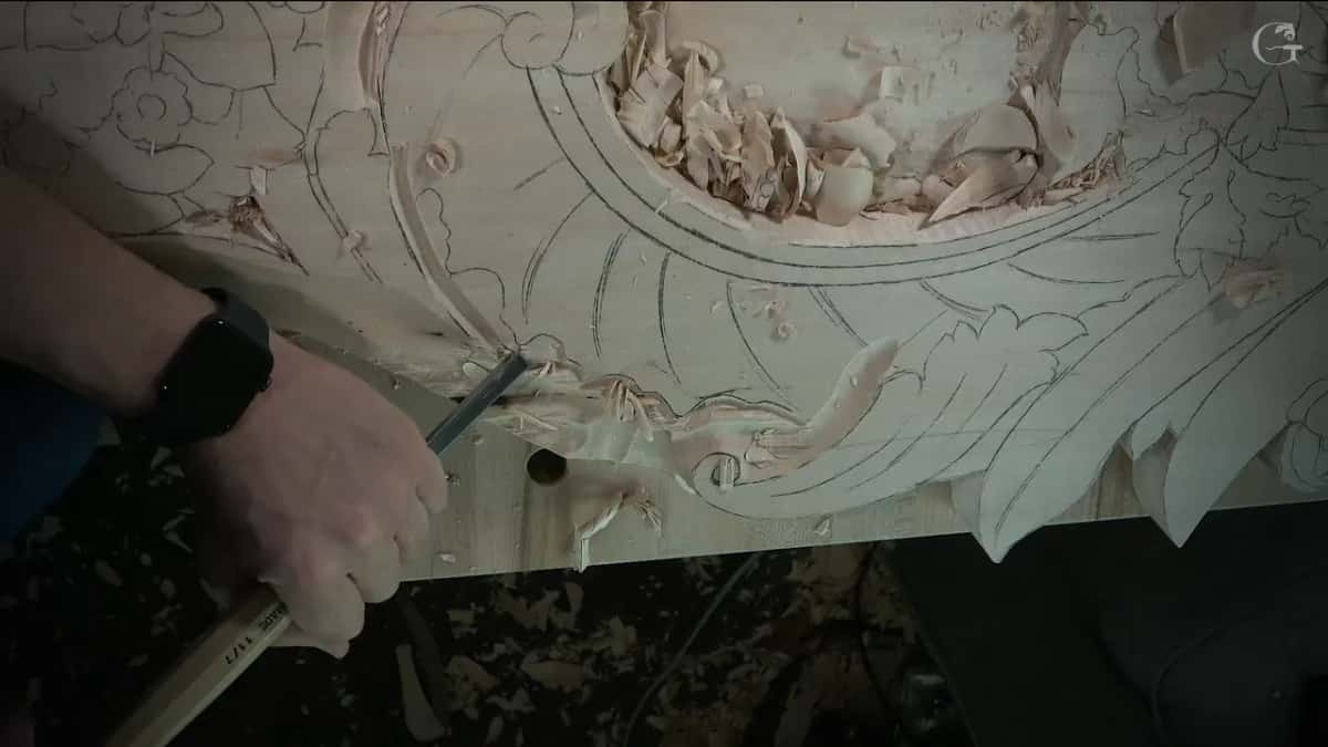 Chips gathering along the leaf edge as a small tool follows its outline next to the bench holes