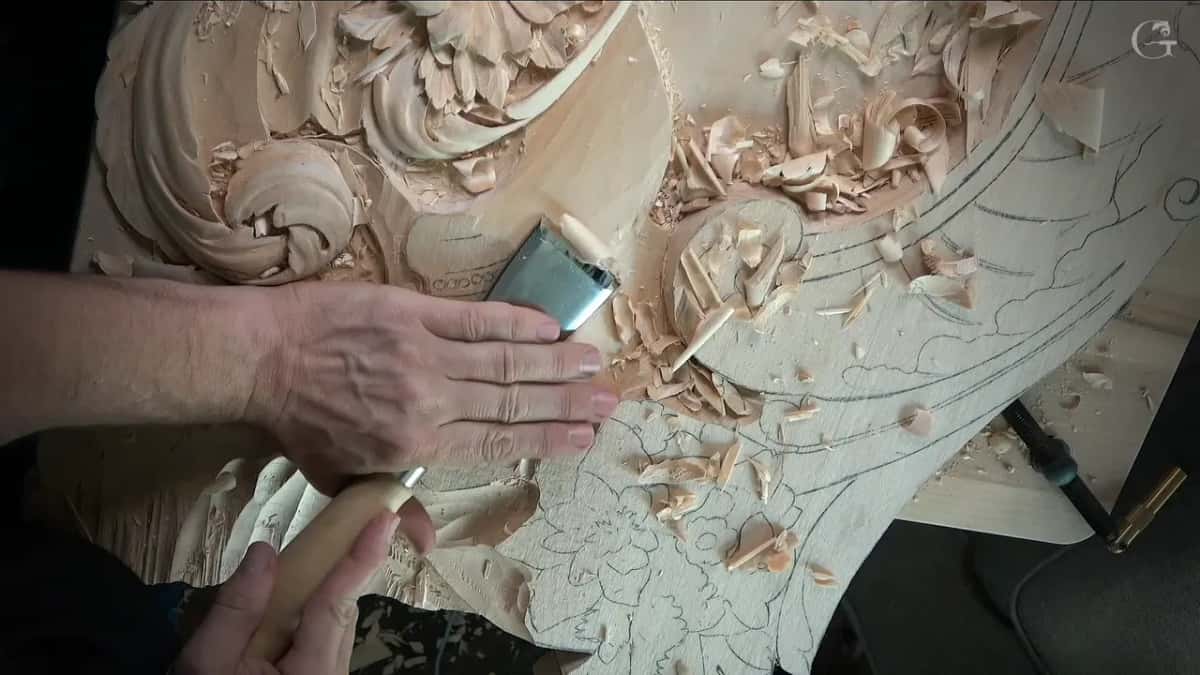 Palm flat on the board, tool resting