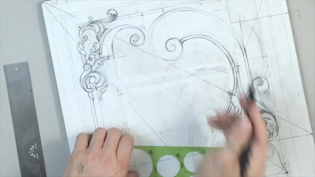 Green plastic circle template resting on the drawing next to a steel rule, one hand blurred as it moves across