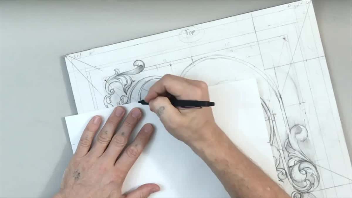 Blank paper held on the drawing, a pencil marking the width onto its edge