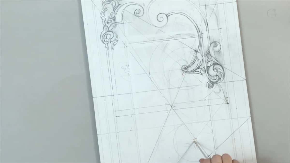 Arcs swung over the drawing, a compass and fingertips just in view at the bottom edge