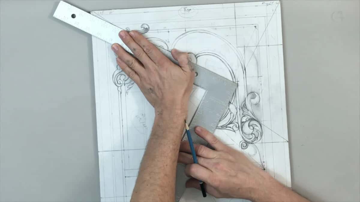 Both hands hold a metal square on the drawing, a blue pencil at its lower edge