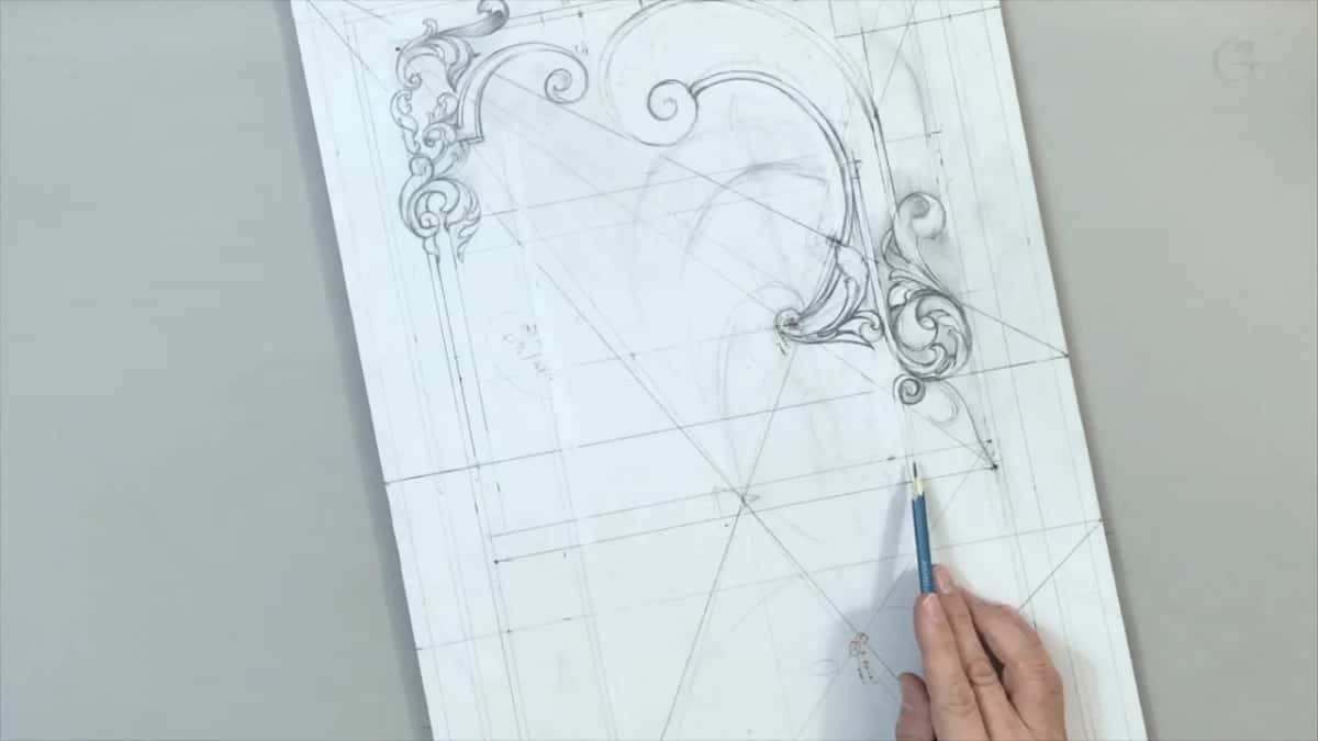 Blue pencil working low on the sheet below the scrolled corner