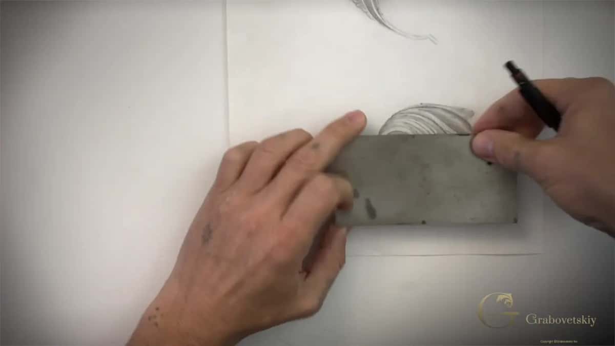 Steel card held square against the drawing while a pen follows its edge