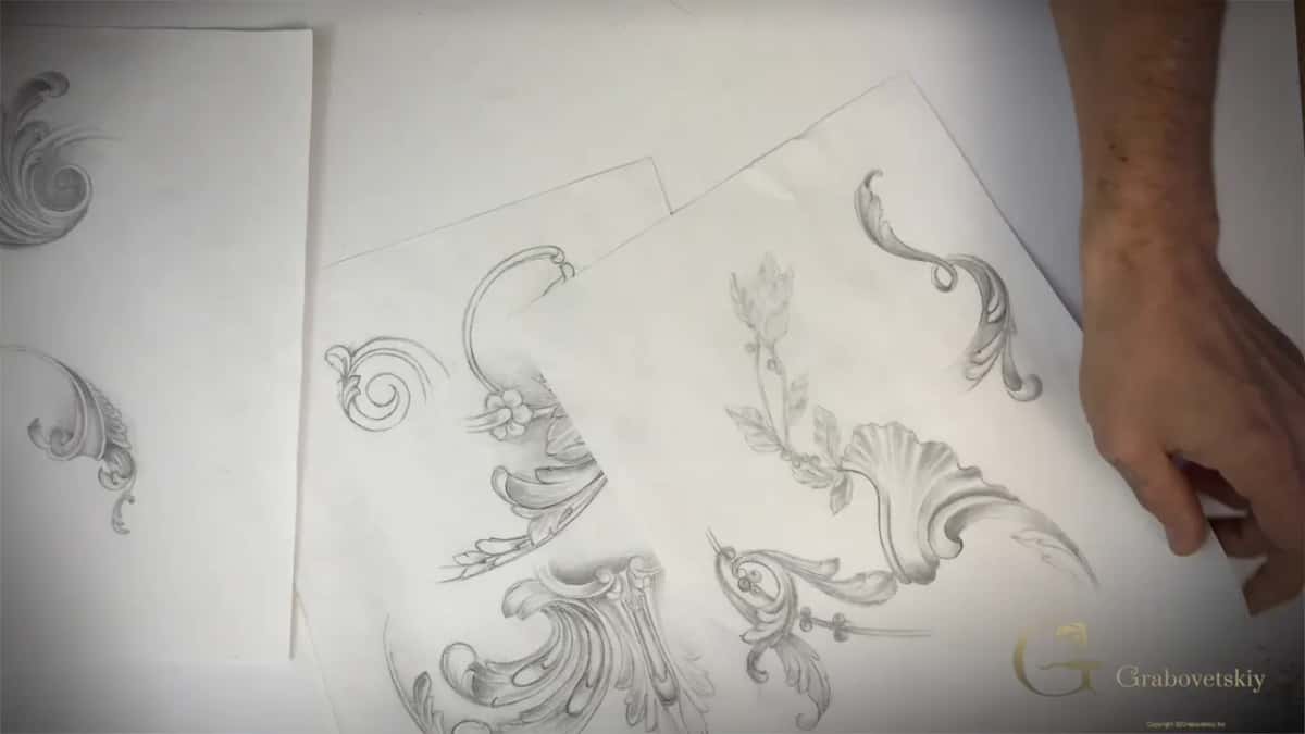 Pencil sketches of acanthus scrolls spread across white paper