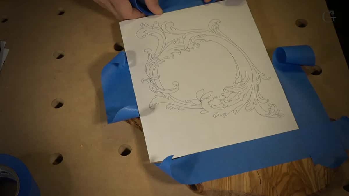 Pattern and blue tape Printed acanthus pattern laid over the olive slab, blue tape already marking its borders on two sides