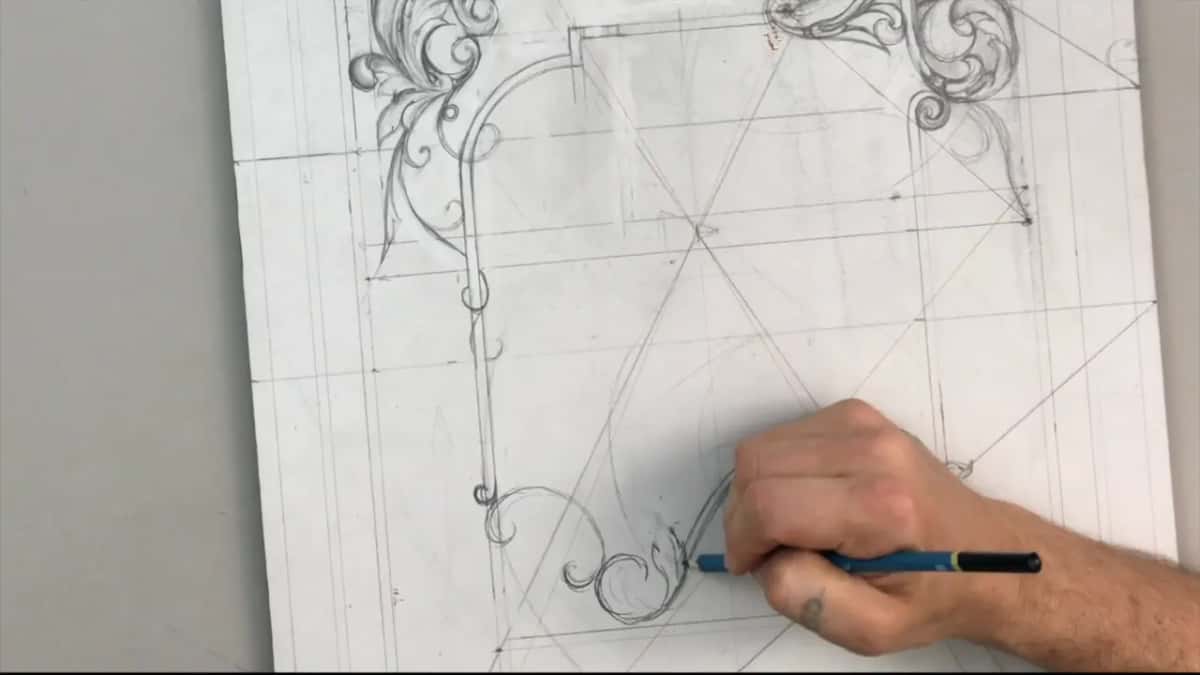 Hand with a blue pencil at the left end of the scroll near the foot of the upright drawing