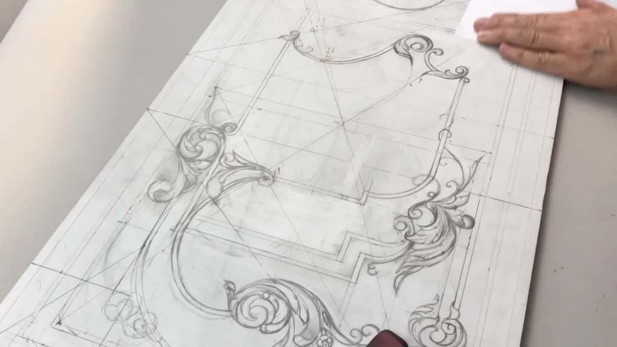 Hand flat on a white sheet of paper over the top corner of the board