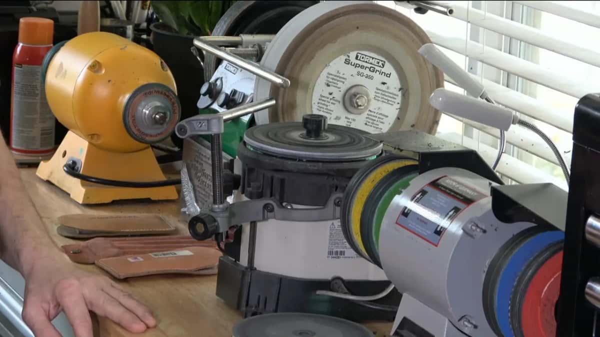 Tormek SuperGrind wheel, a Koch machine and leather paddles crowded onto one bench top