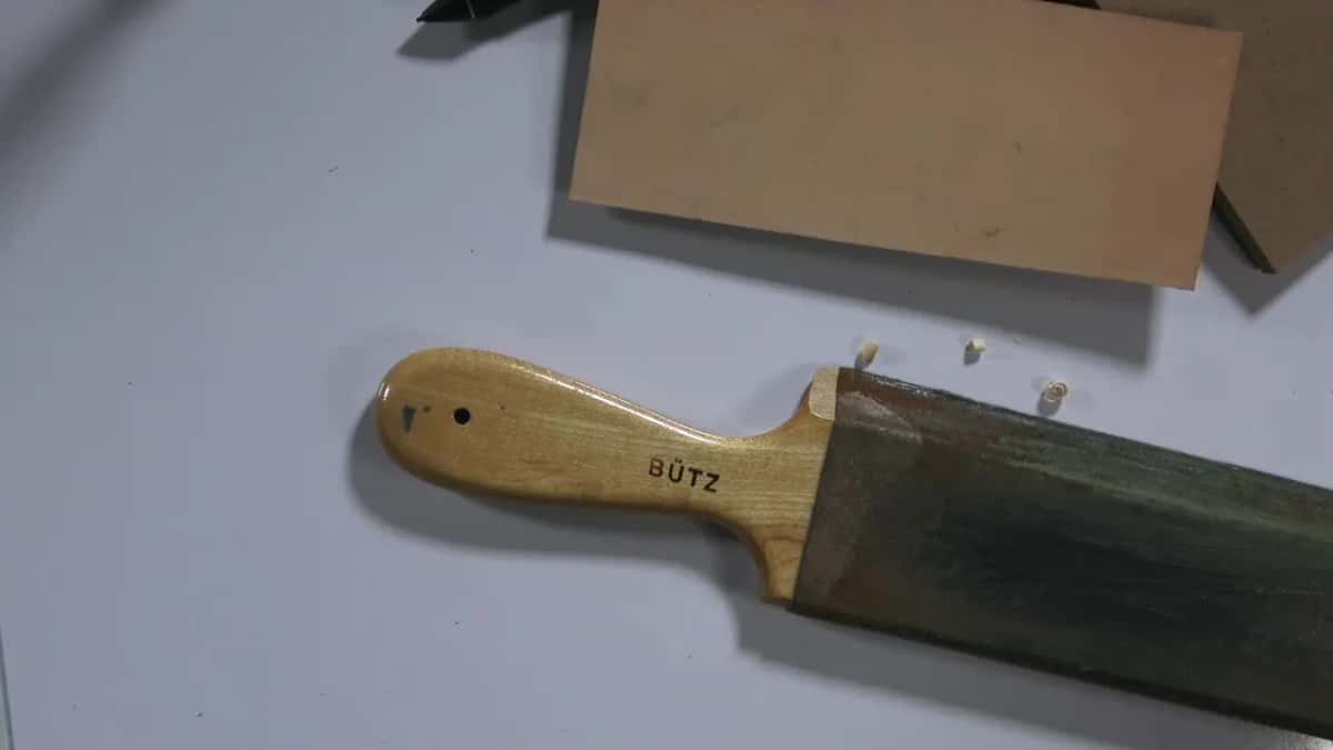Butz paddle strop loaded green beside bare leather