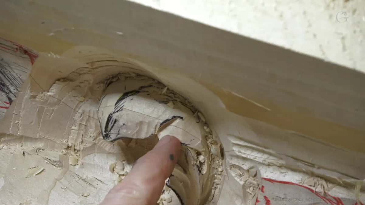 Pointing at the problem One fingertip points at a shape drawn in pencil inside the hollow