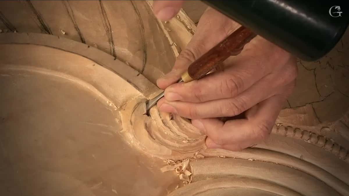 Handle tipped down so a slim tool reaches the curl's end