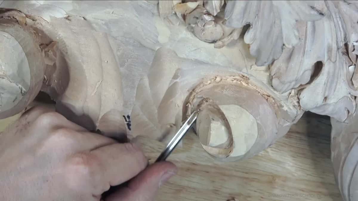 From the left, a slim tool reaches into the barrel.