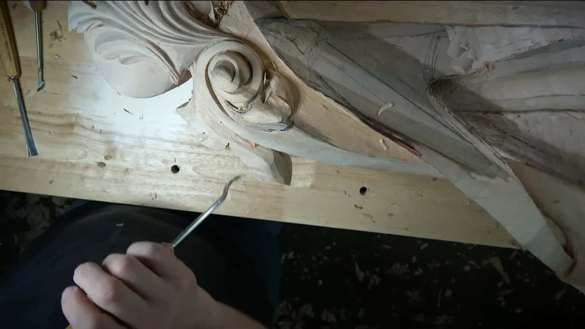 Spoon tip hovering over the bench beside the scroll