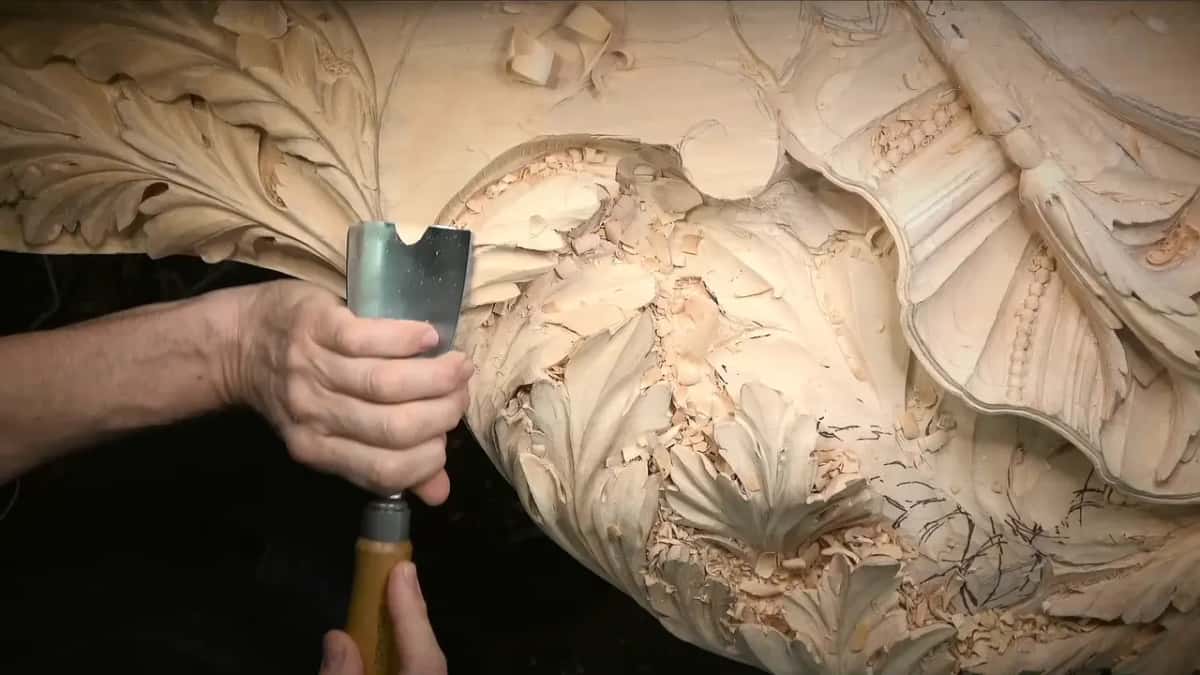 Wide straight gouge held upright in two hands