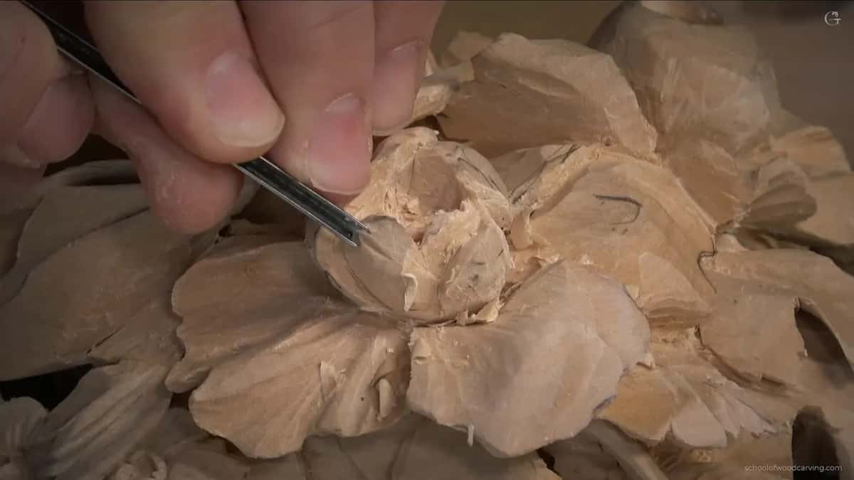 Close in on the swirl, a slim V tool entering from the upper left between two layers of petals