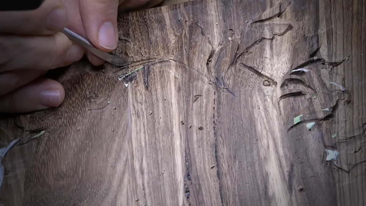 Knife paring the stem's corner into an arc.
