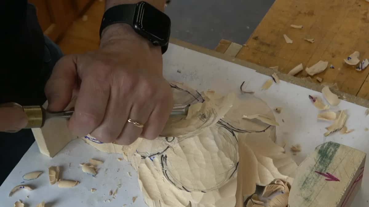 Chisel held almost level and rolled across the domed tulip, both hands low over the work
