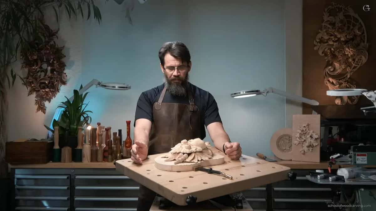 Both hands on the piece, deciding which blade to reach for and taking longer over it than the cut will take