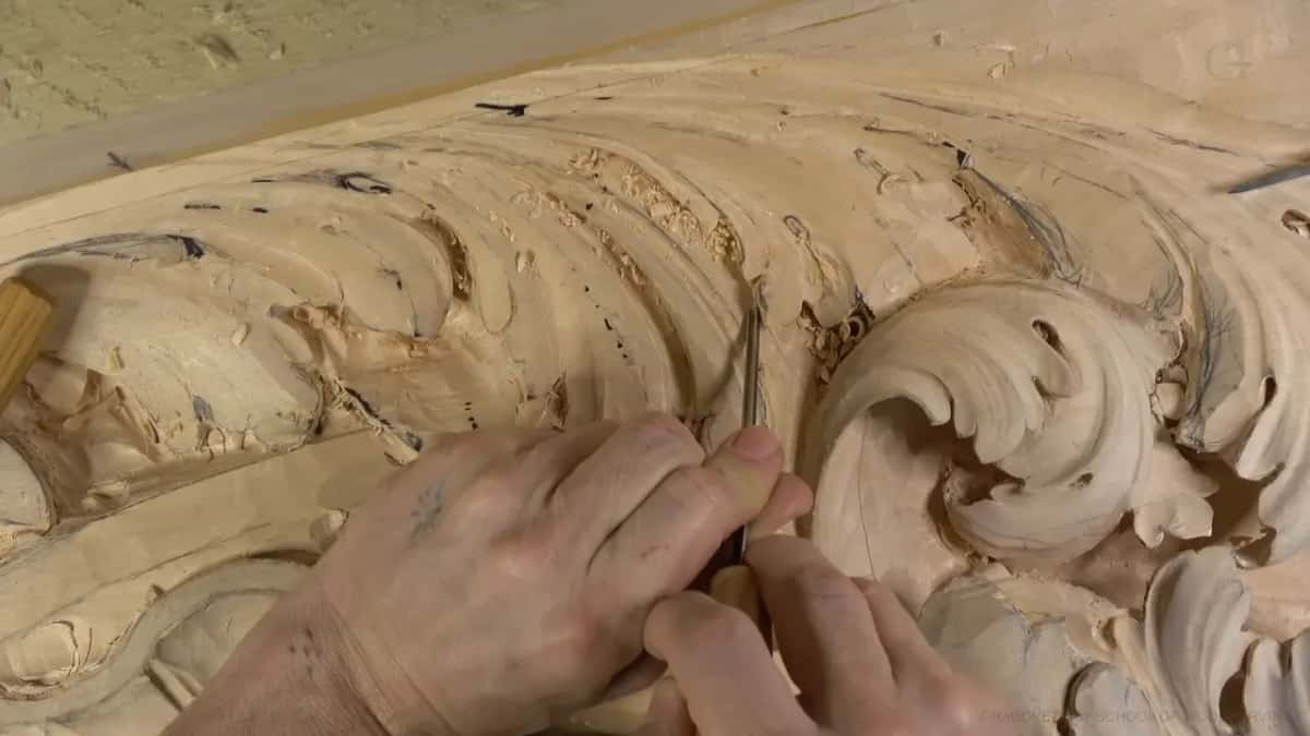 Both hands steer a thin blade into a small pocket.