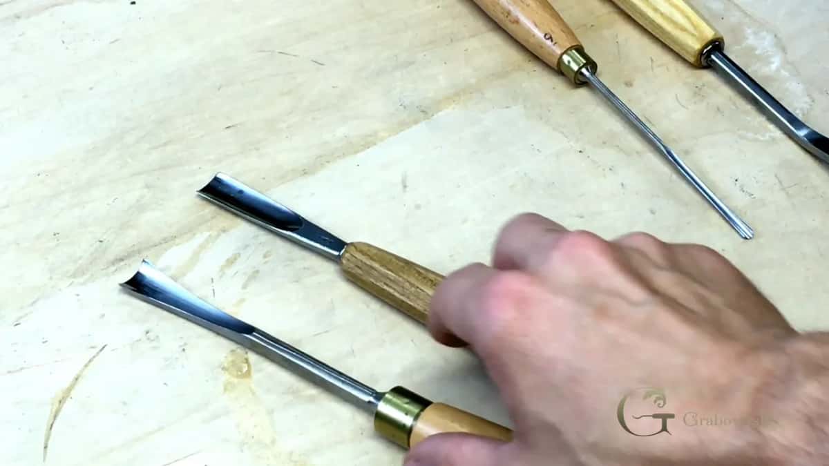 Reaching for one of four tools.