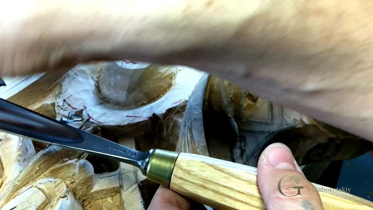 Blade laid flat against a strop, the last thing that happens before it goes back into the wood.