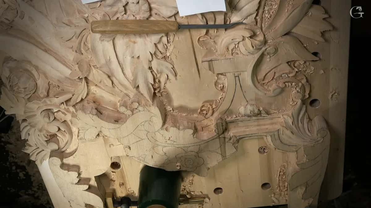 Panel from above with a chisel laid across it and a green mallet standing at the bottom edge