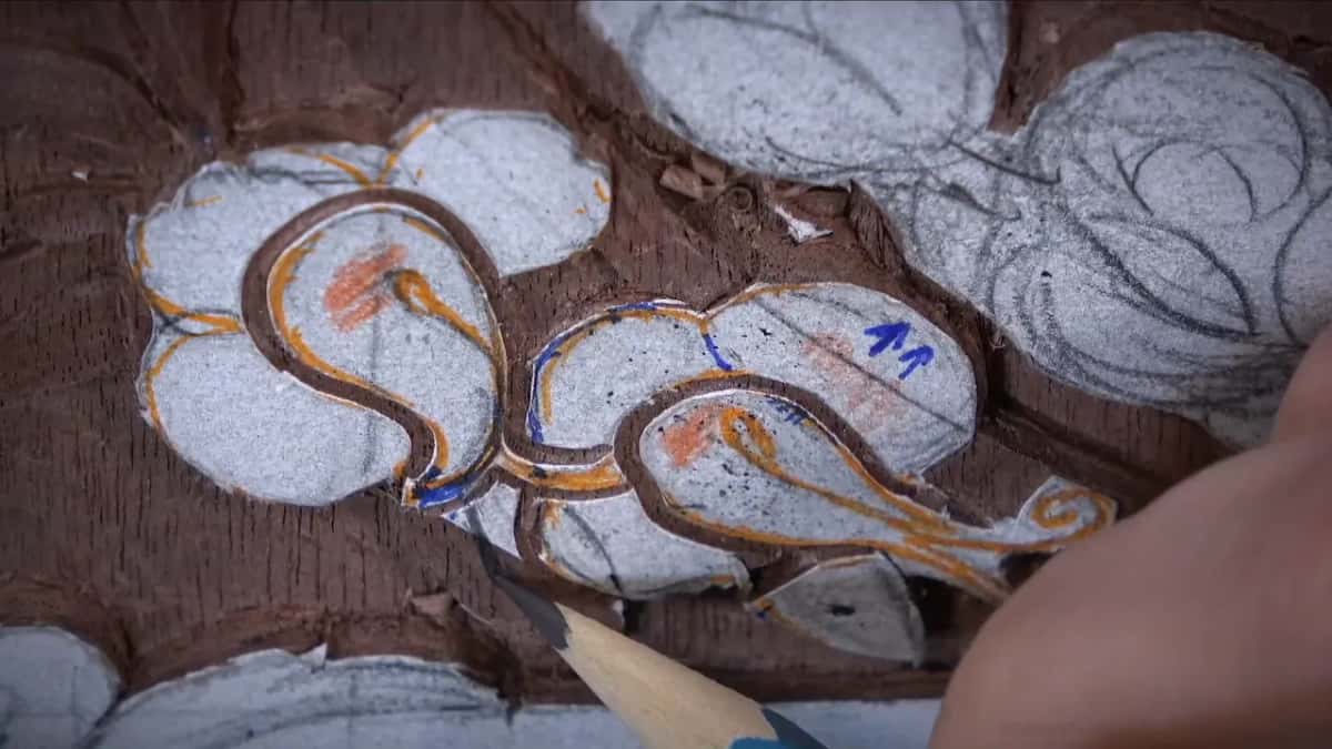 Pencil tip arriving among leaves drawn in orange and blue
