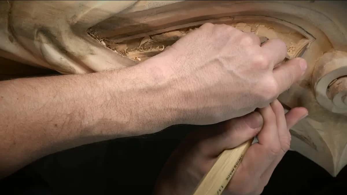 Same stamped handle cleaning the groove from another angle, shavings in the panel above