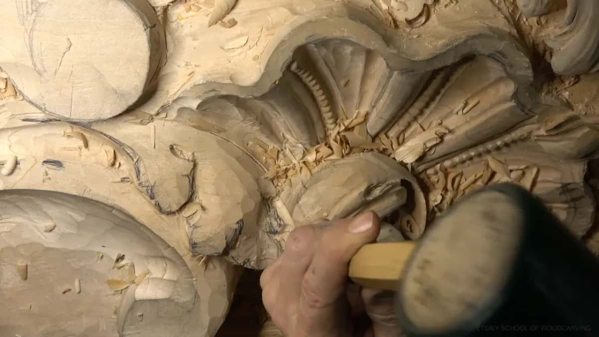 Why the stock is thick Black mallet head beside the gouge, and the thick blank still carrying its pencil drawing
