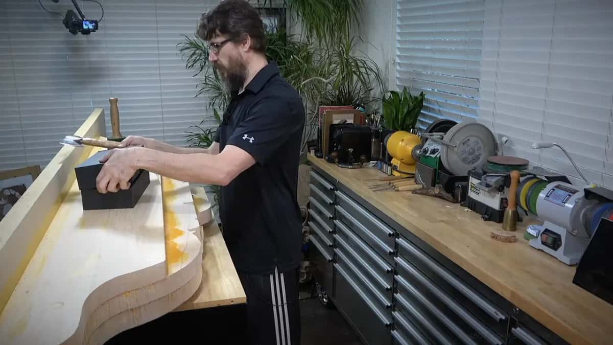 Along the length Driving the gouge with the mallet