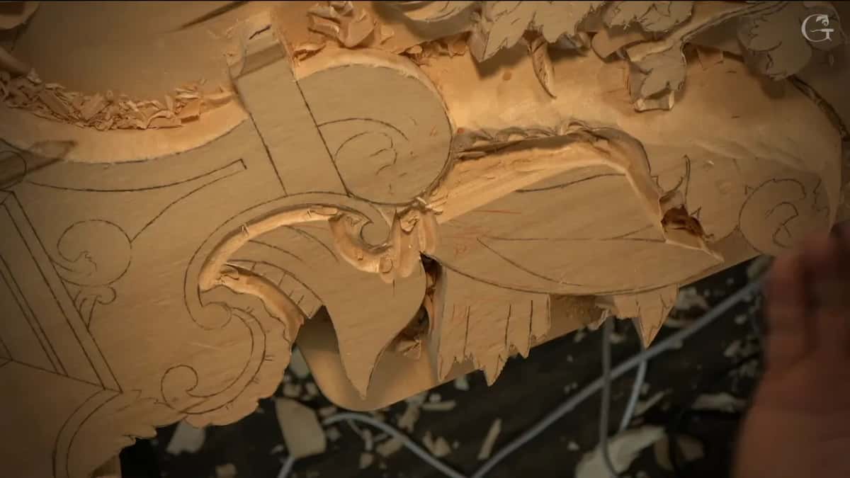 Close view of a drawn frame shape, the wood beside it already lowered and full of tool marks.