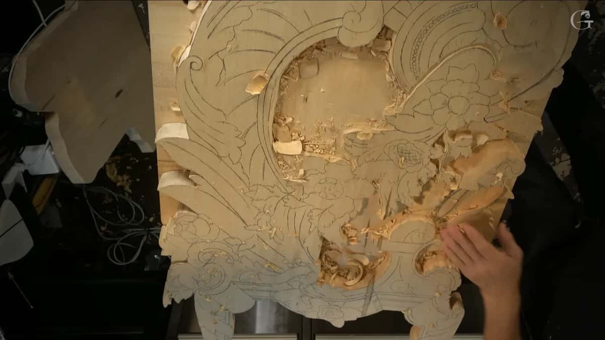 From high above, the full board shows drawn flowers still waiting for the gouge.