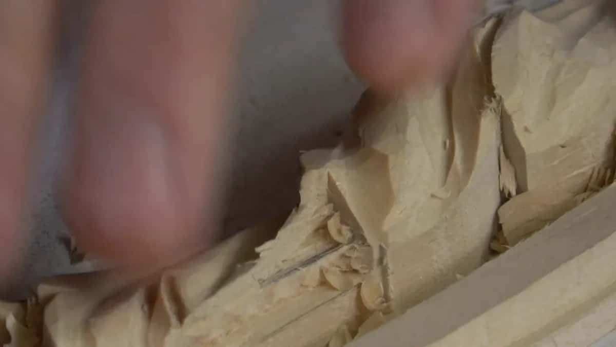 Forearm across the board where the moulding runs on beneath the leaf and out the other side.