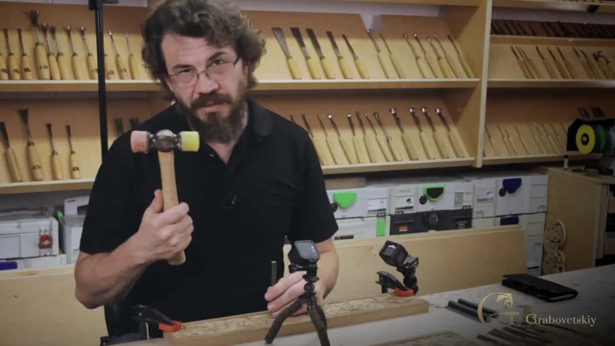 Yellow and pink plastic faces on a carpenter's mallet